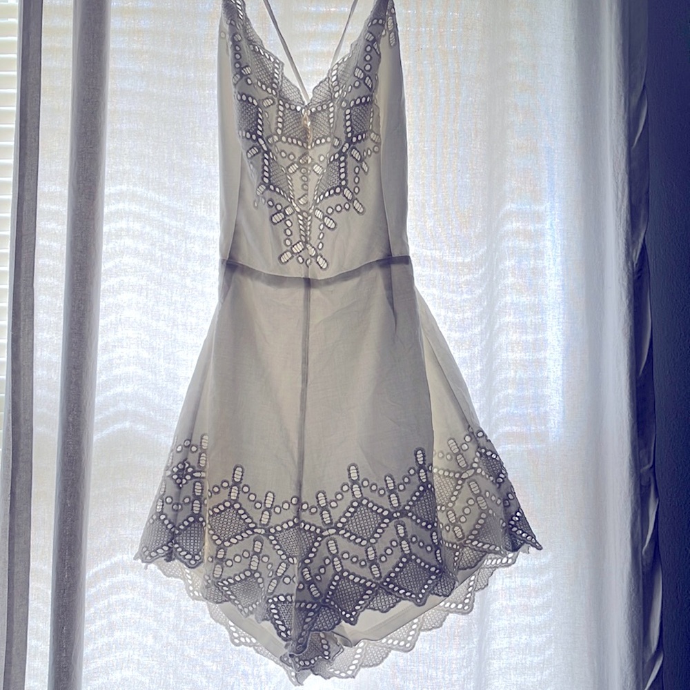White Cotton with Lace Backless Romper. Tie and zipper details
